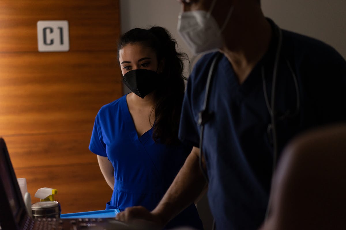 Doctors in Face Masks and Scrubs