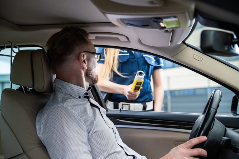 Police Officer Conducting Breathalyzer Test on Driver